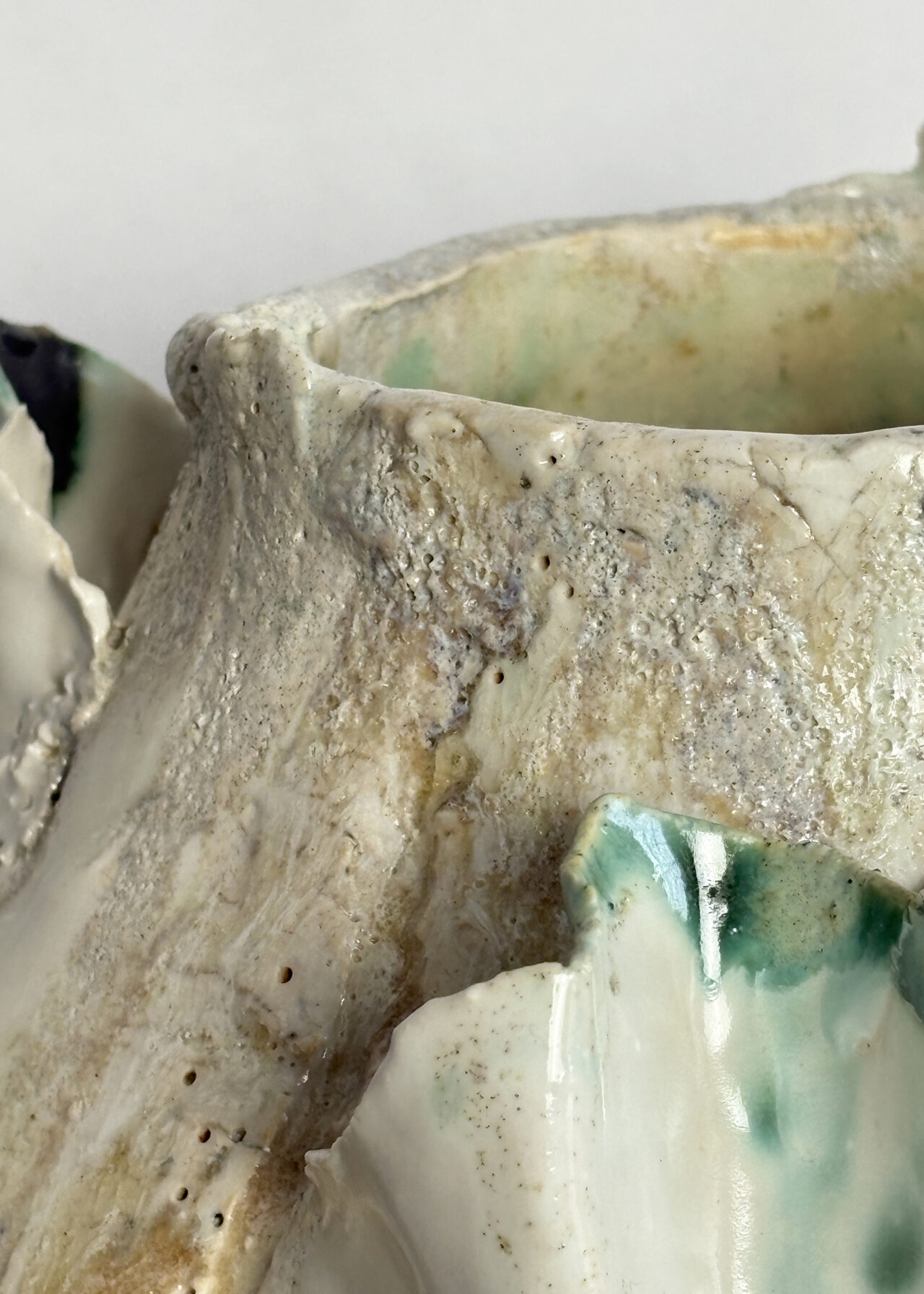 Closeup of vessel no 54 - Handbuilt stoneware ceramic vessel with cracked, blistered surface and layered oxide glaze by Rebeccah Pailes-Friedman