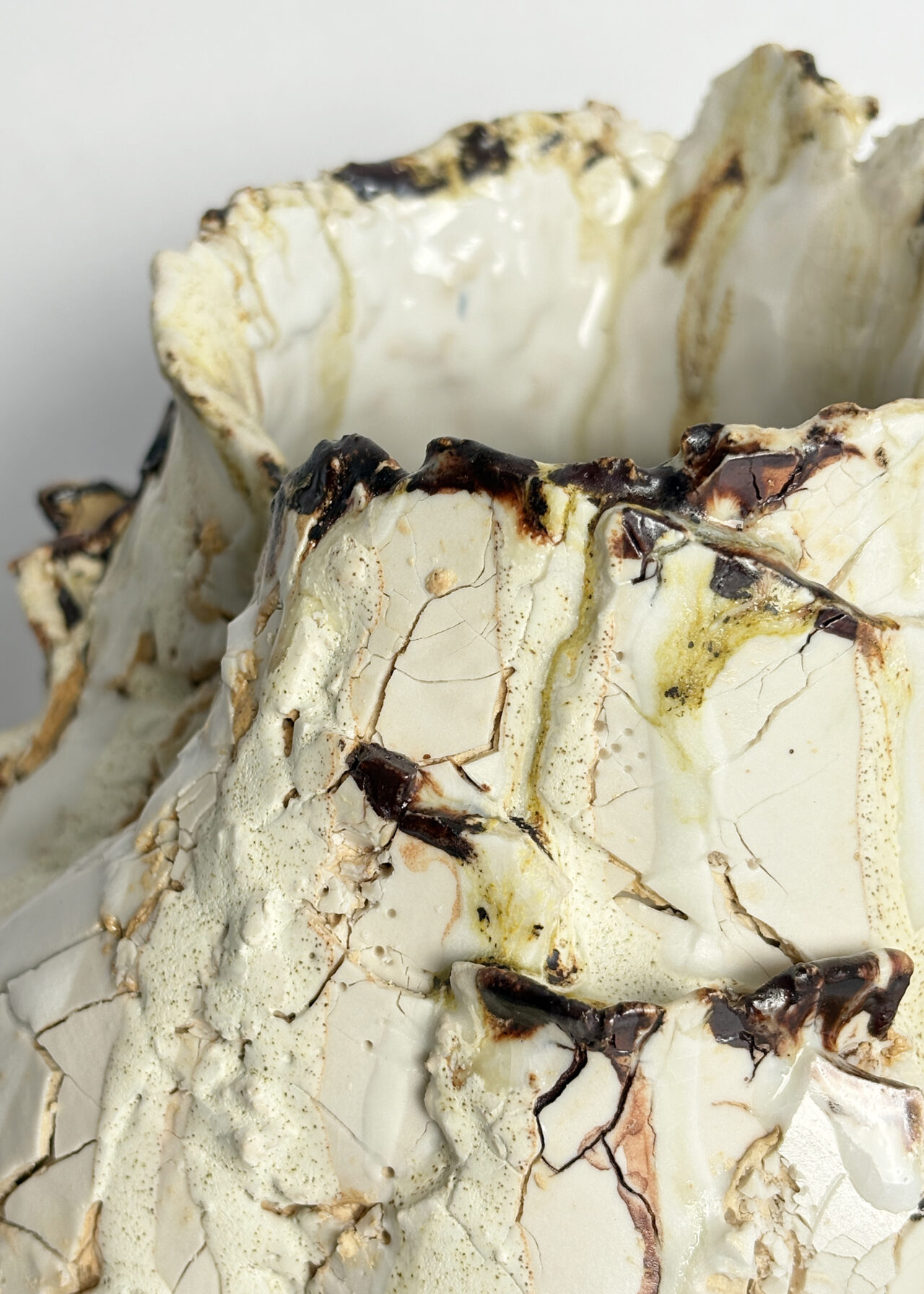 Close up of Vessel no. 55 - Handbuilt ceramic vessel with cracked textured surface and layered glaze by Rebeccah Pailes-Friedman