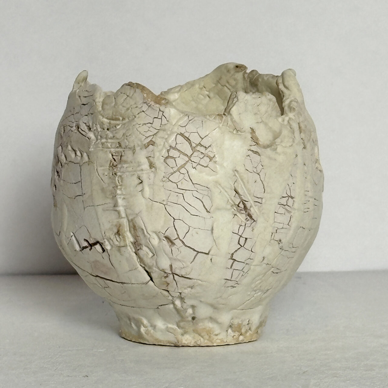 no. 88 Small ceramic vessel with matte white glaze, crackled surface, and subtle incised marks with soft beige undertones.