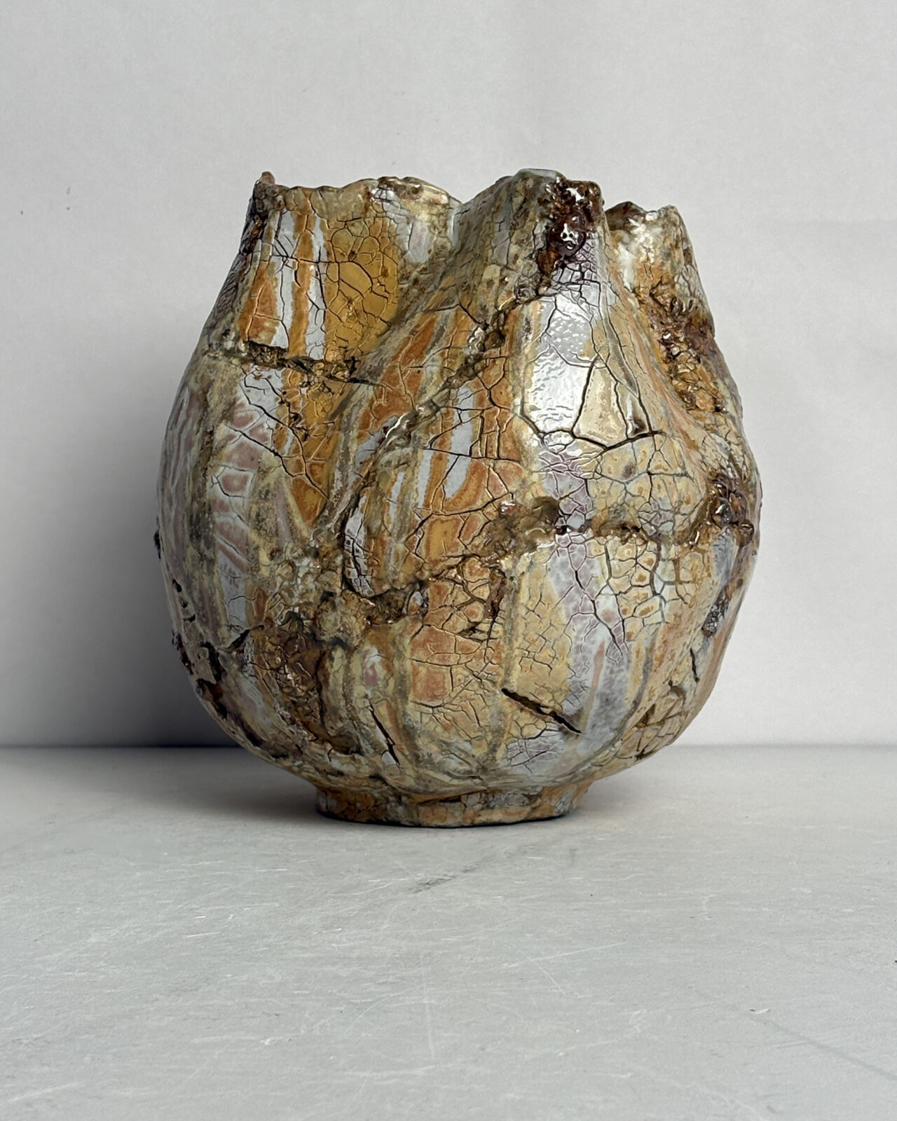 Alternate angle of Vessel No. 58 highlighting the rounded sculptural form, fractured glaze patterns, and flowing mineral-like surface variations.