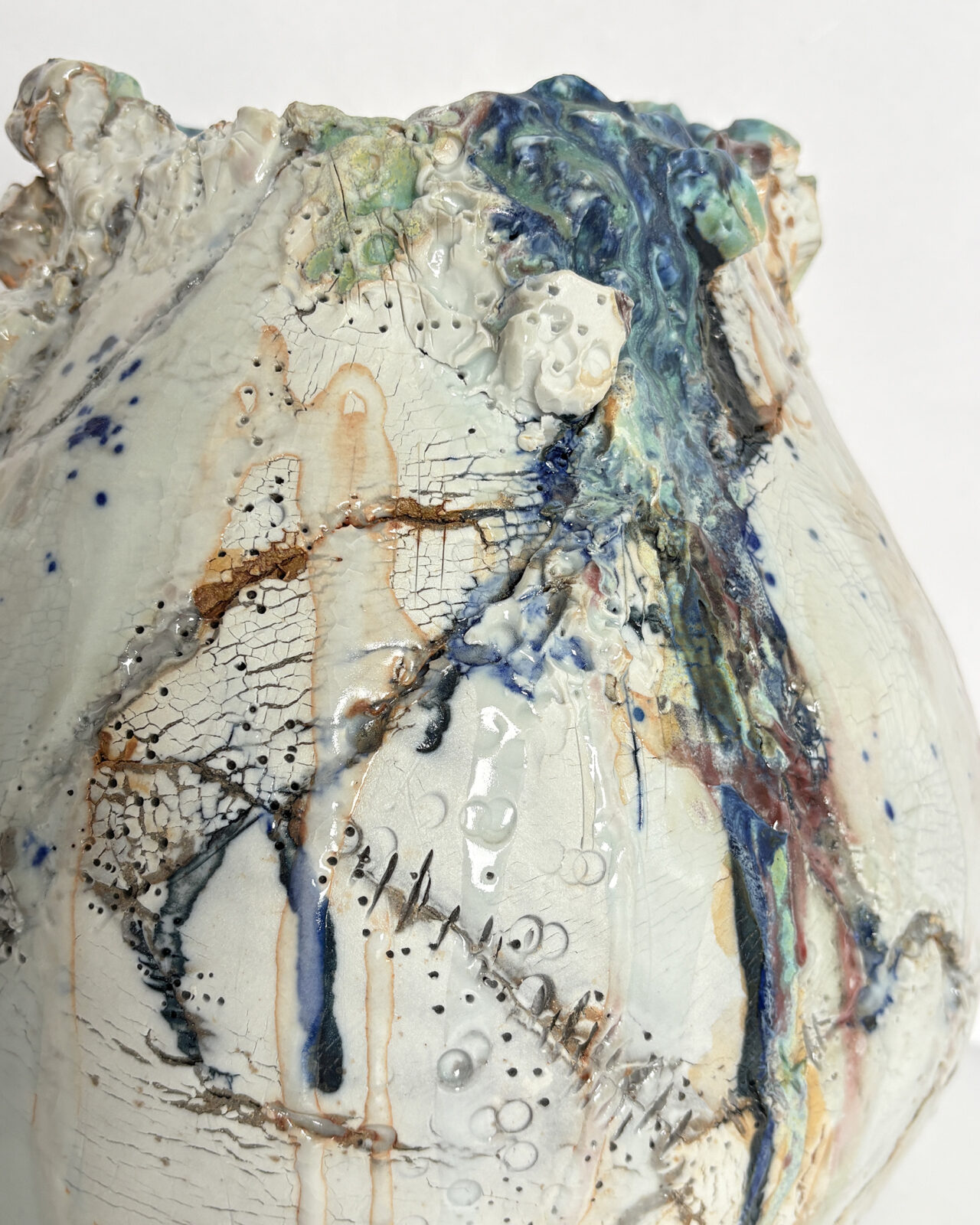 Vessel no. 66 - close up to show texture and color off white, blue and turquoise with rust red areas in the cracked surface