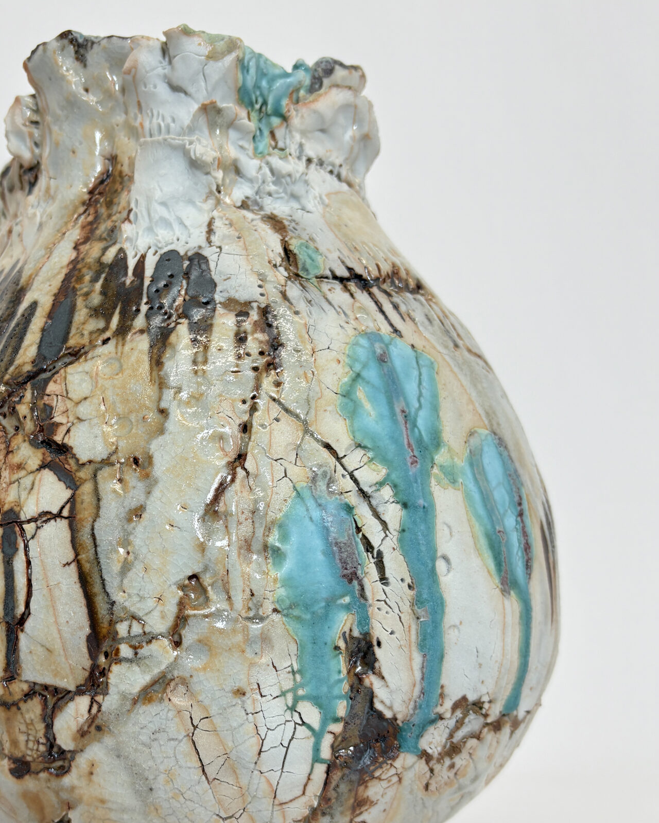 Vessel no. 67 - Detail of the vessel with 3 turquoise drippy dots with dark rust brown markings