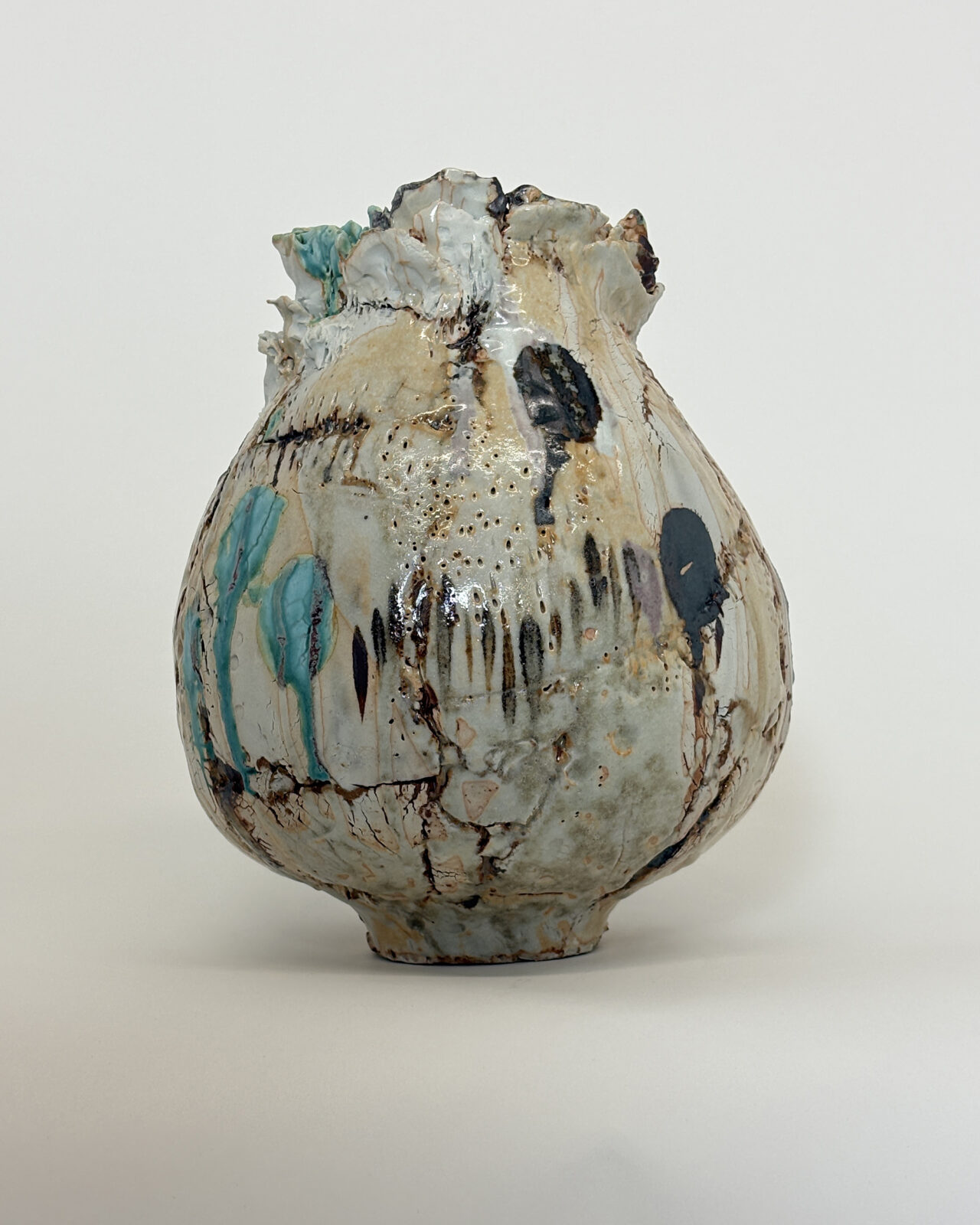 Vessel no. 67 - Image showing a ceramic vessel with 3 turquoise dots and 2 large dots of rust brown in a iff white and pale yellow ground