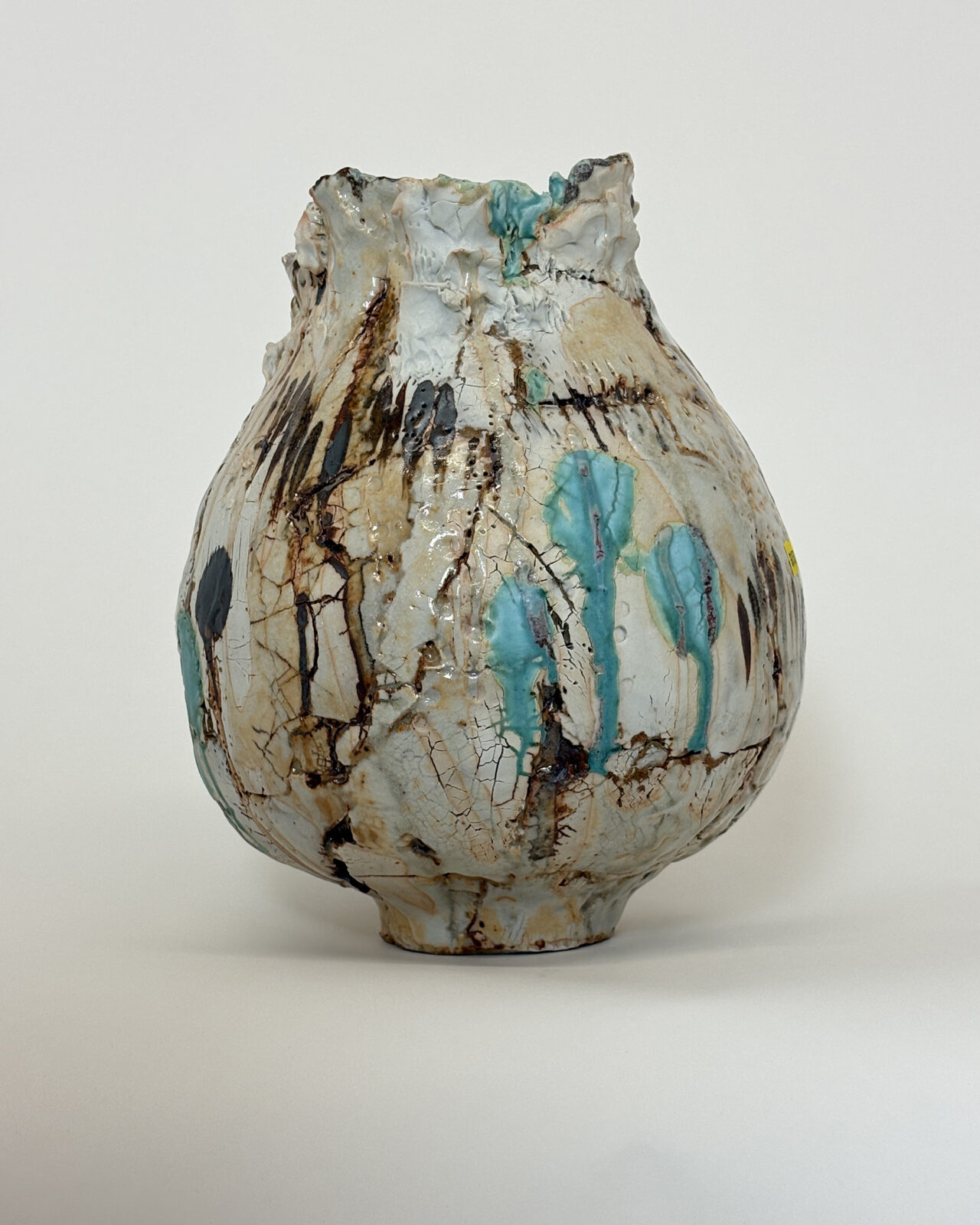 Vessel no. 67 - side 2 of the ceramic vessel with 3 turquoise dots and 2 large dots of rust brown in a off white and pale yellow ground