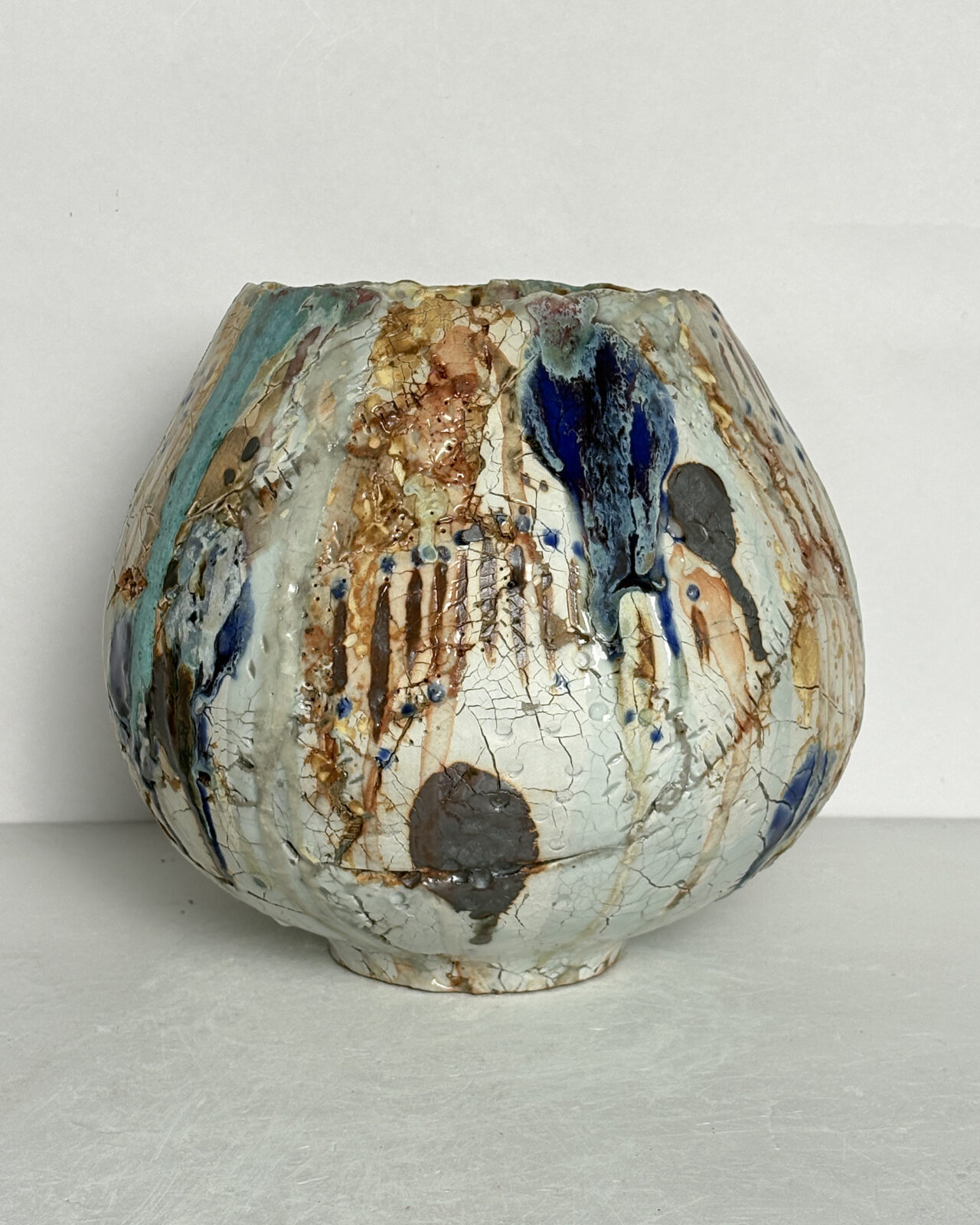 Vessel no. 70 - Side 3 of a round moon jar shaped ceramic vessel with 2 large china blue and turquoise dots and warm yellow interior