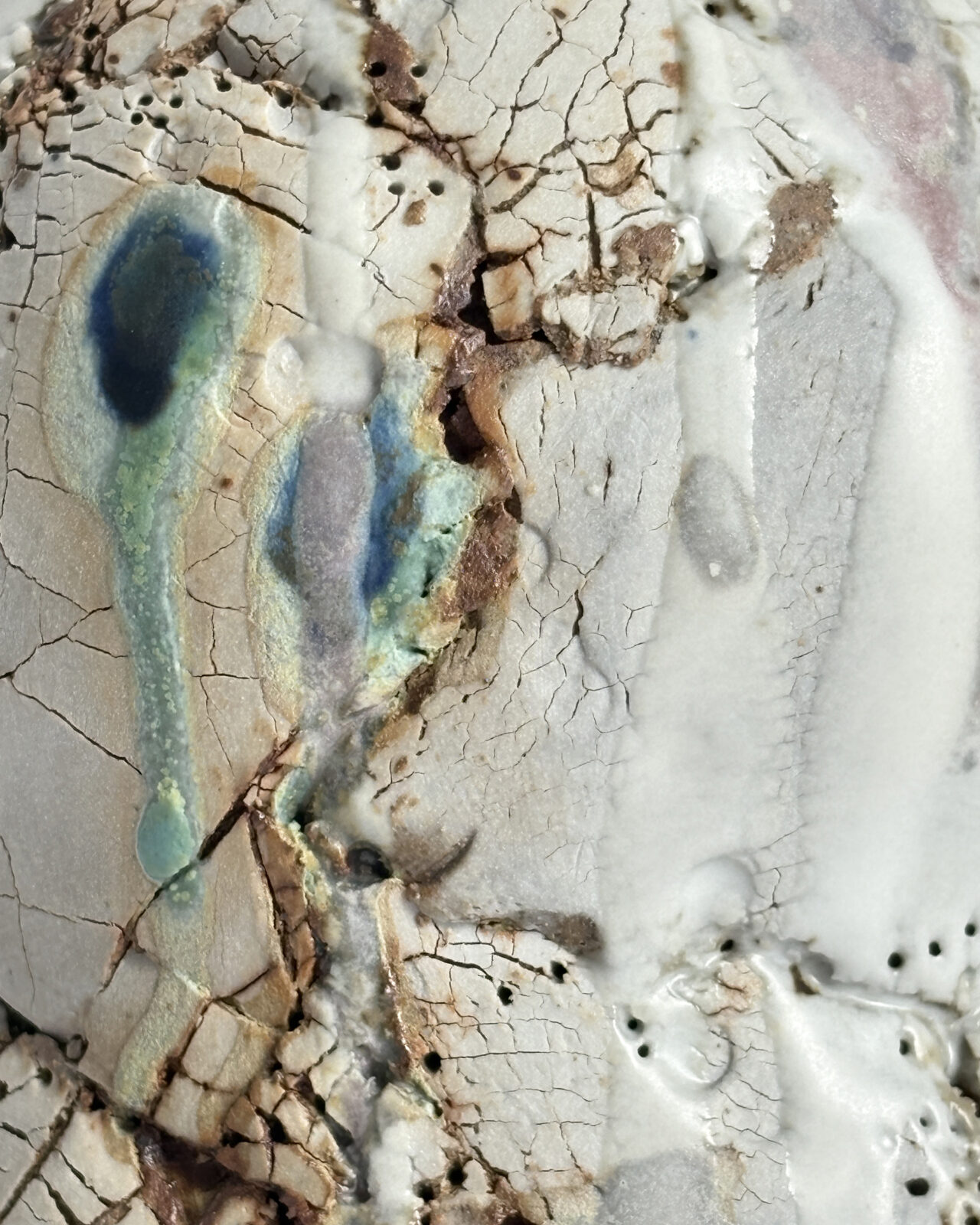 Macro detail of Vessel No. 61 showing cracked clay, layered white glaze, exposed earthen tones, and turquoise and blue glaze pooling.