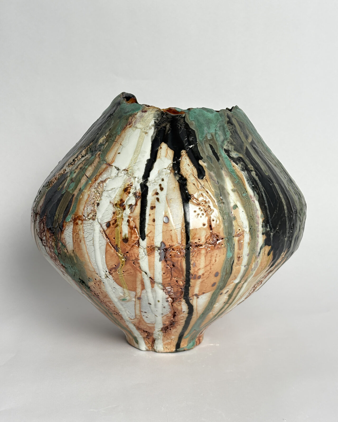 Alternate view of Vessel No. 73 with vertical black, white, turquoise, and rust-colored glaze markings emphasizing its rounded, asymmetrical form.