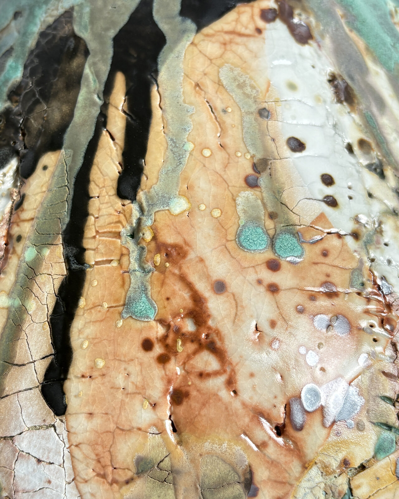 Macro detail of Vessel No. 73 showing fine crackling, layered glazes, dark linear marks, turquoise pools, and rust-colored ceramic surfaces.